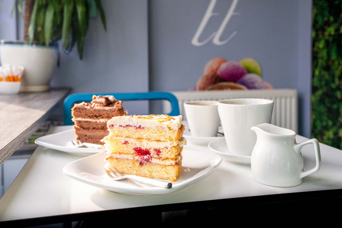 Two slices of cake with coffee and tea